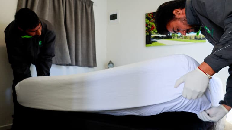 Team members fixing the bed