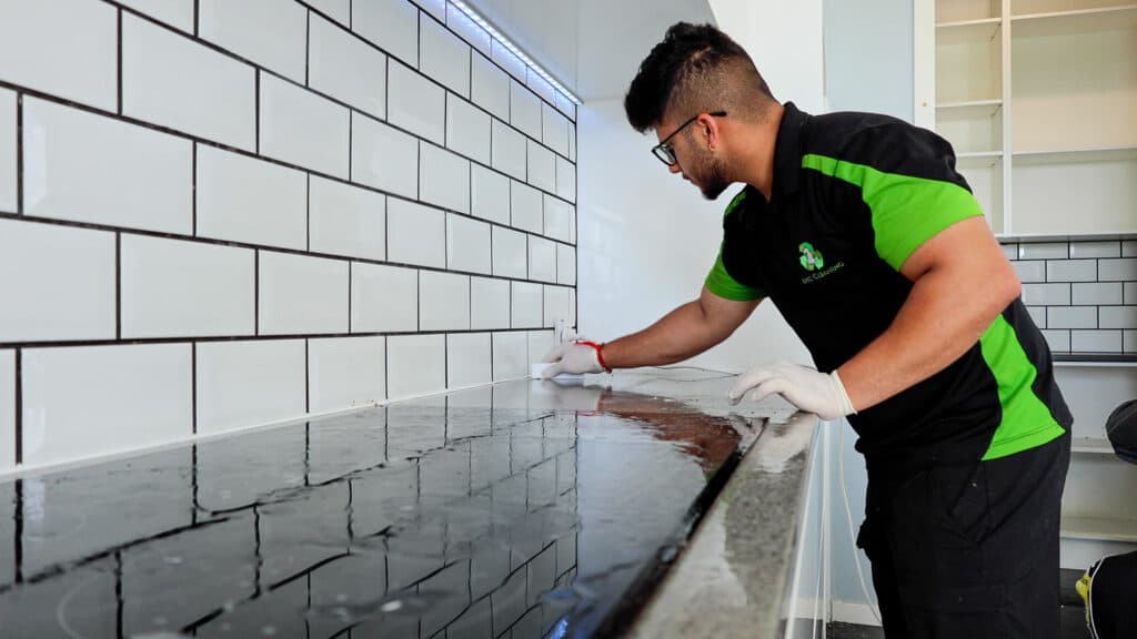Team member cleaning the kitchen top