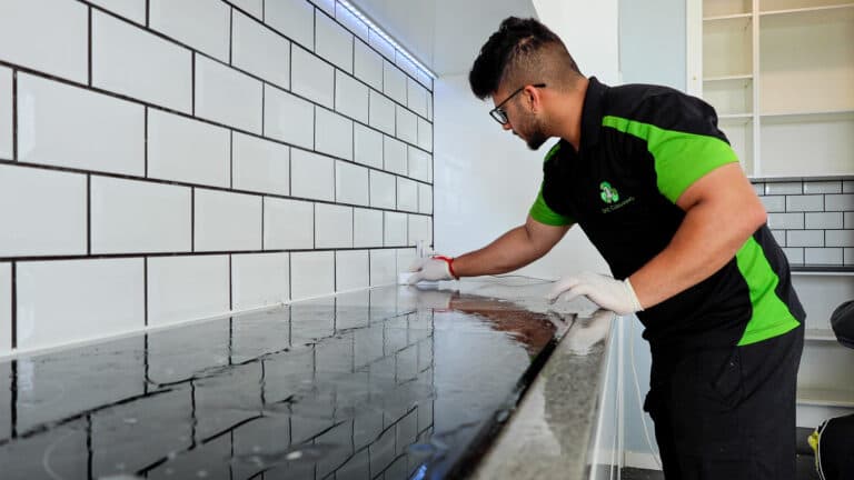 Team member cleaning the kitchen top