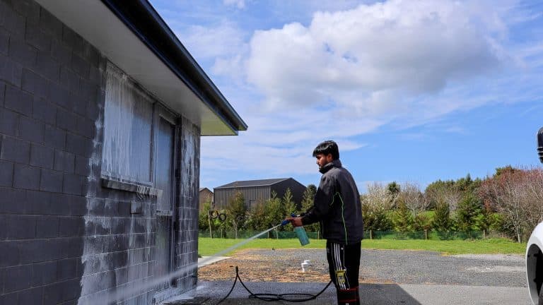 Team Member Washing a House
